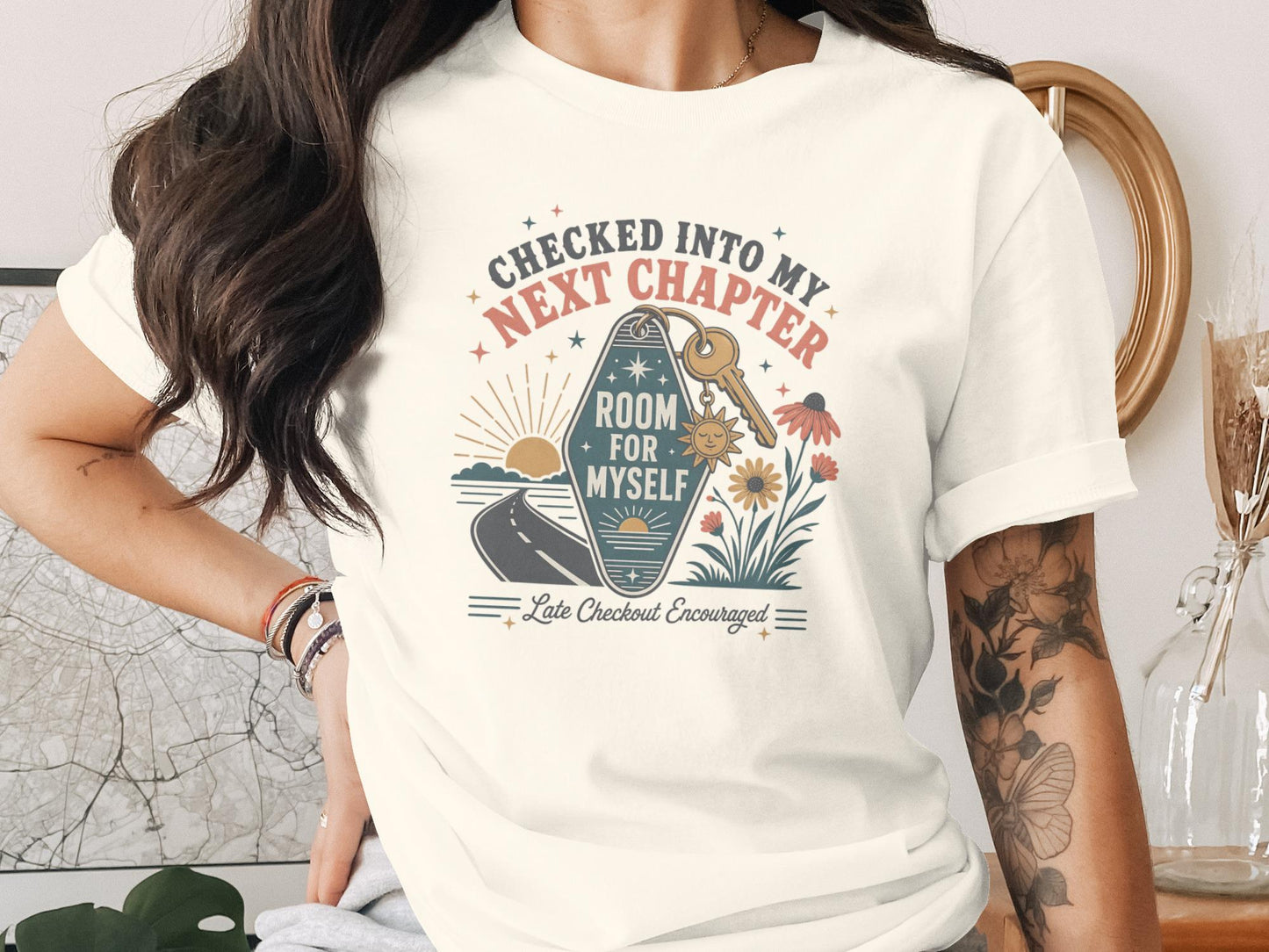 T-shirt graphic with "Checked Into My Next Chapter Room For Myself" text.