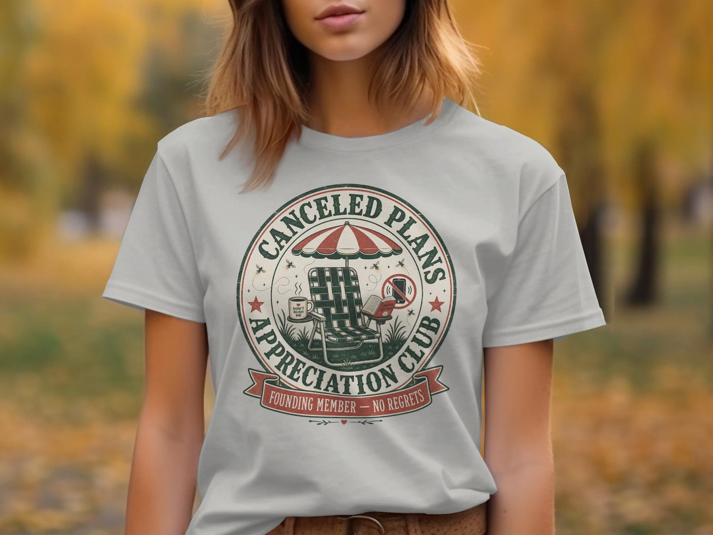 Light gray t-shirt with a circular graphic: "Canceled Plans Appreciation Club".
