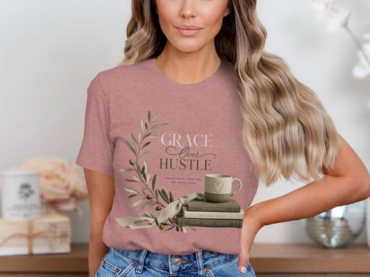 T-shirt with "Grace Over Hustle" text, olive branch, books, and mug.