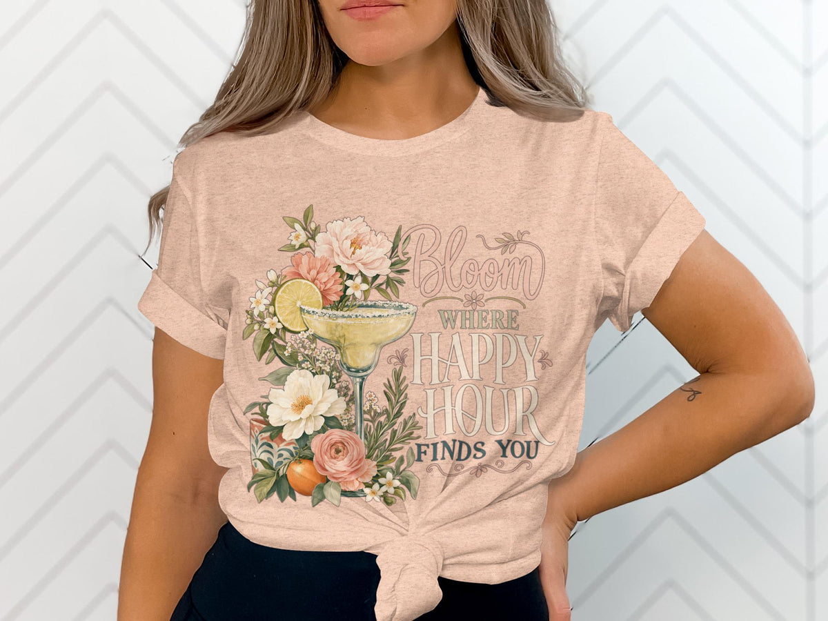 Peach t-shirt with floral margarita and "Bloom Where Happy Hour Finds You" text.