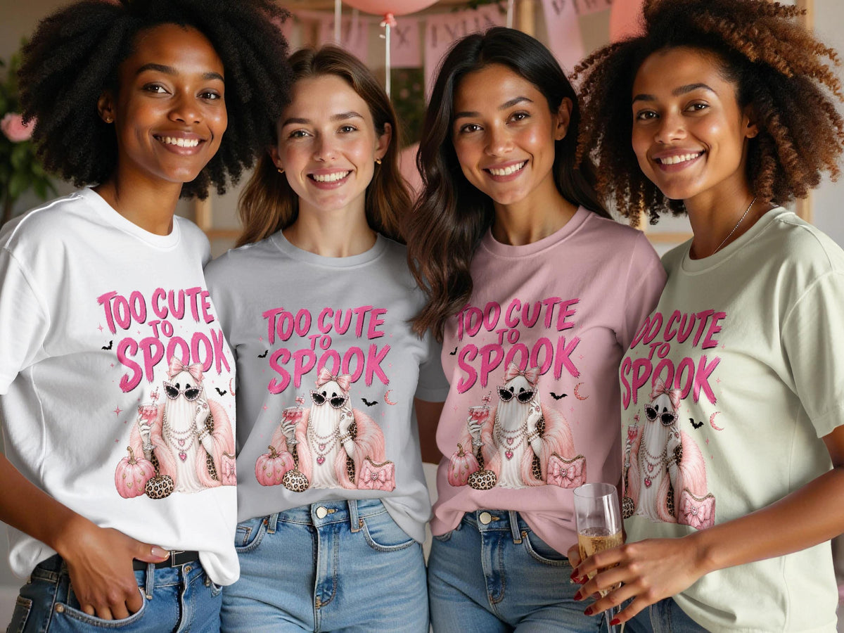 Four women wear t-shirts with "Too Cute to Spook" text and a glamorous ghost graphic.