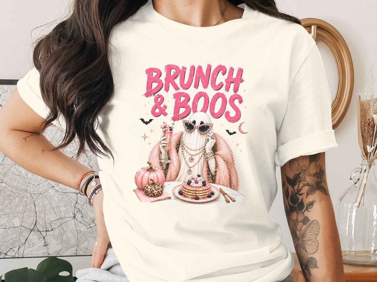 Cream t-shirt with "Brunch & Boos" graphic of a fashionable ghost and pancakes.