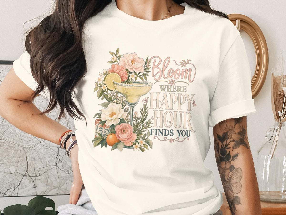 White t-shirt with a floral margarita and text "Bloom where Happy Hour finds you".
