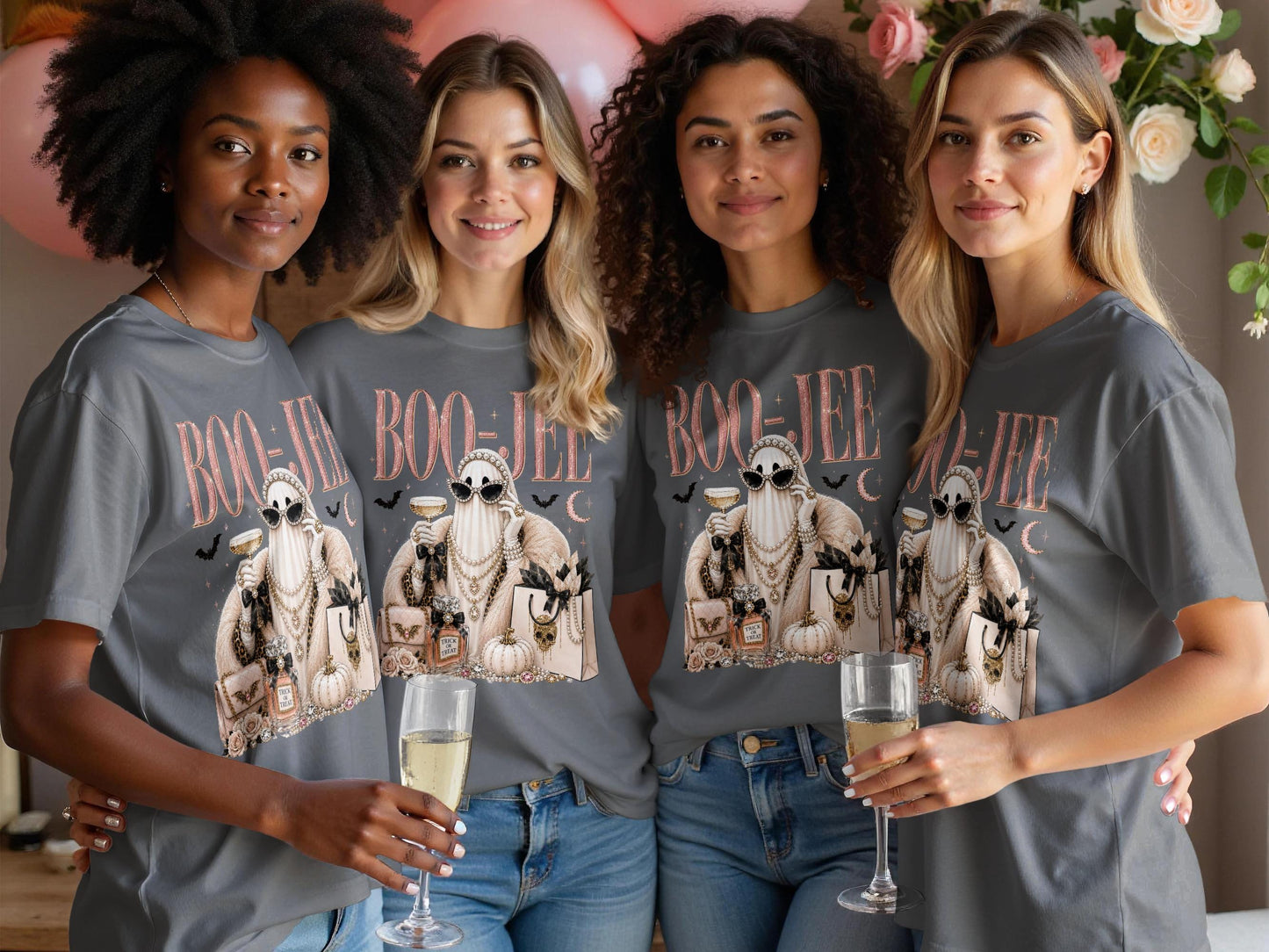 Four women in grey t-shirts with a Halloween ghost graphic and "BOO-JEE" text.