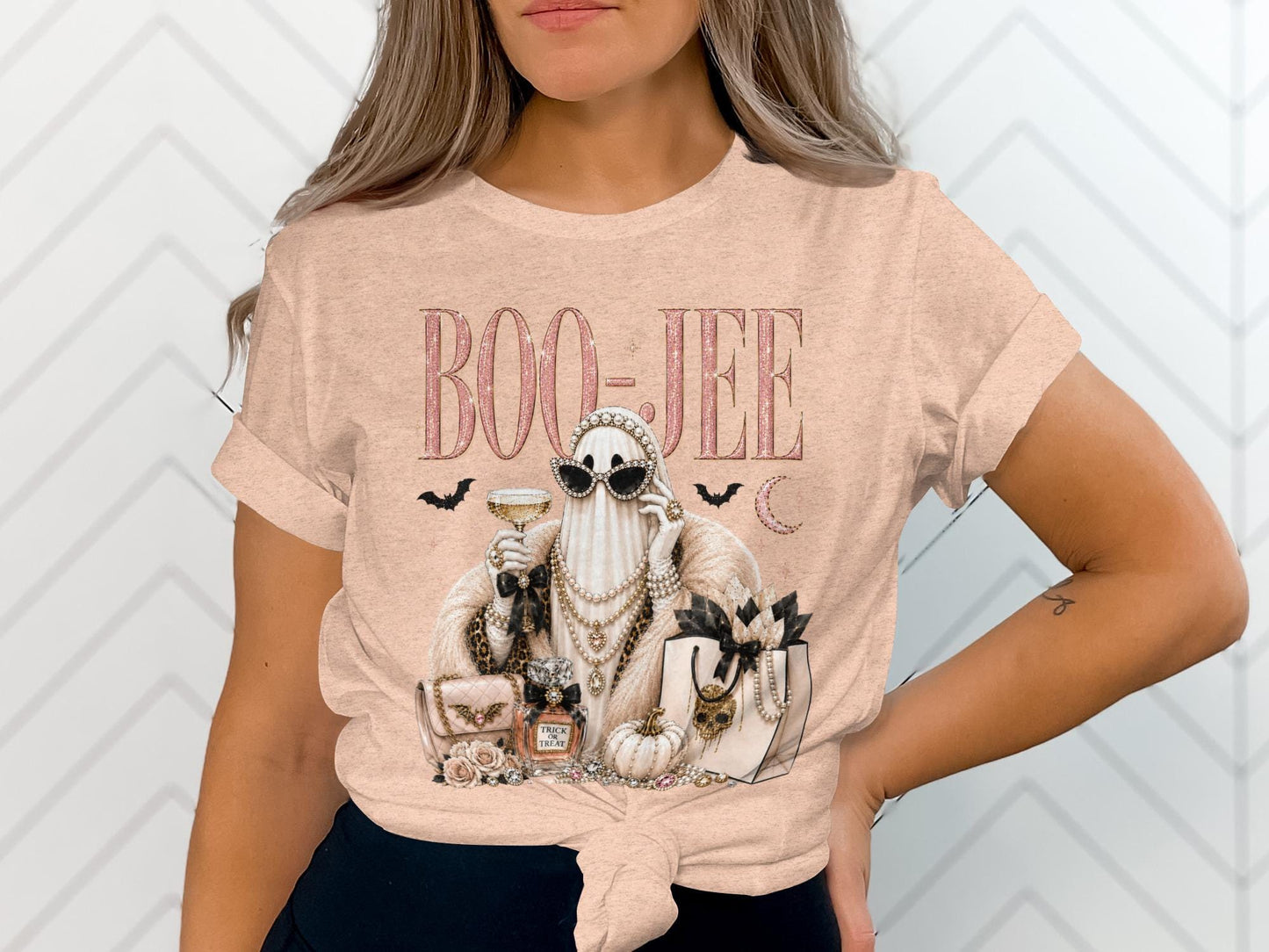 T-shirt graphic with glitter text "BOO-JEE", a fancy ghost, perfume, and shopping bag.