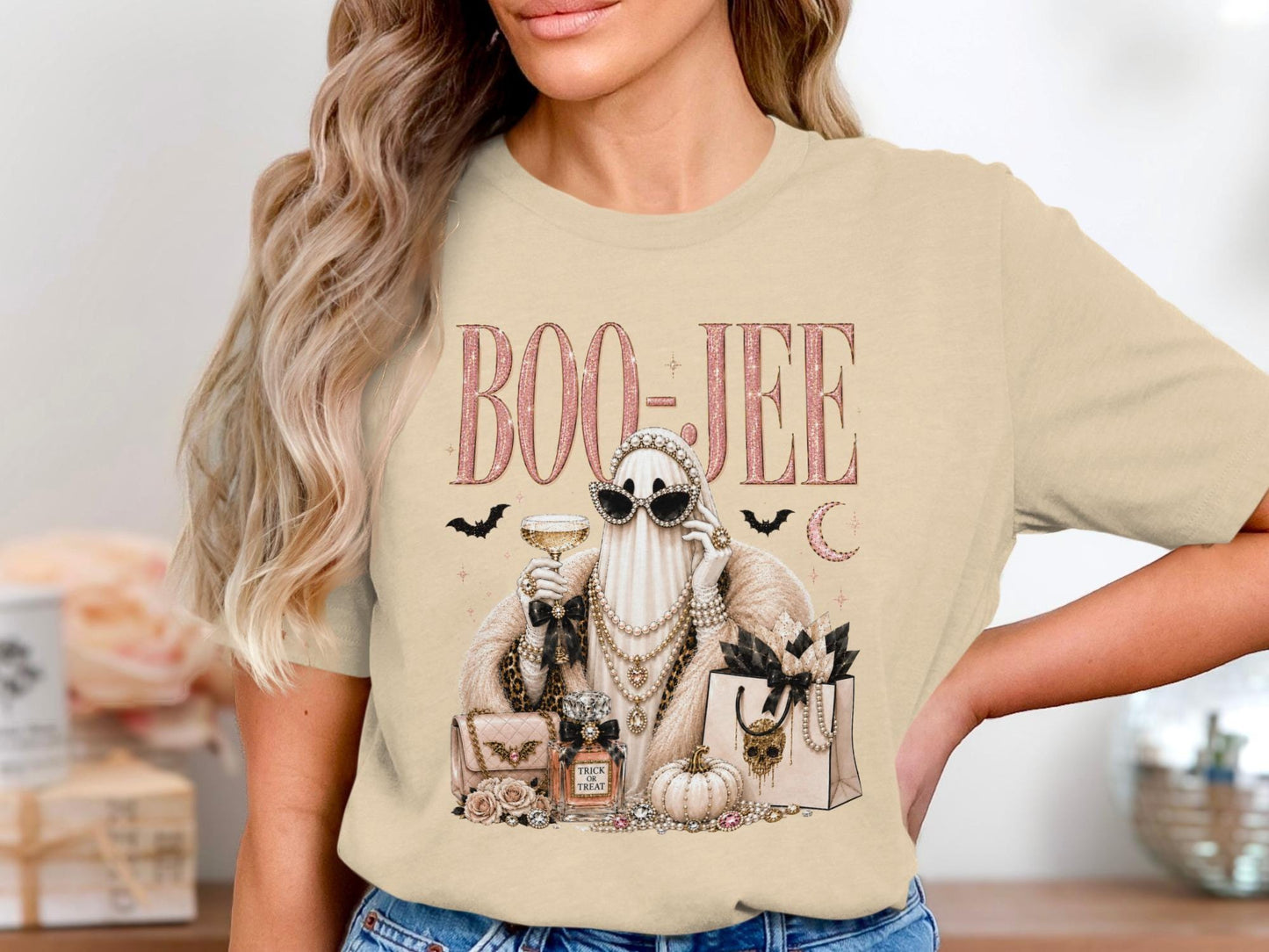 "Boo-Jee" text with a glamorous ghost holding a drink and surrounded by gifts.