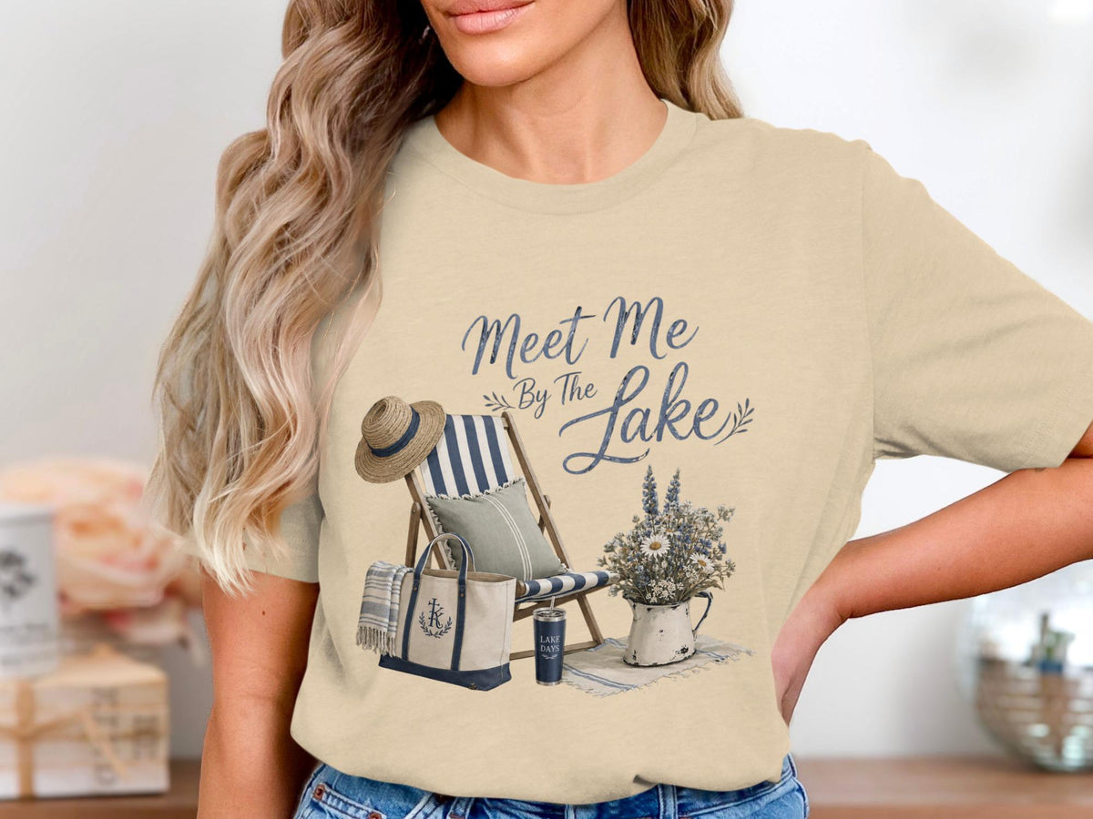 T-shirt with "Meet Me By The Lake" graphic and beach chair scene.